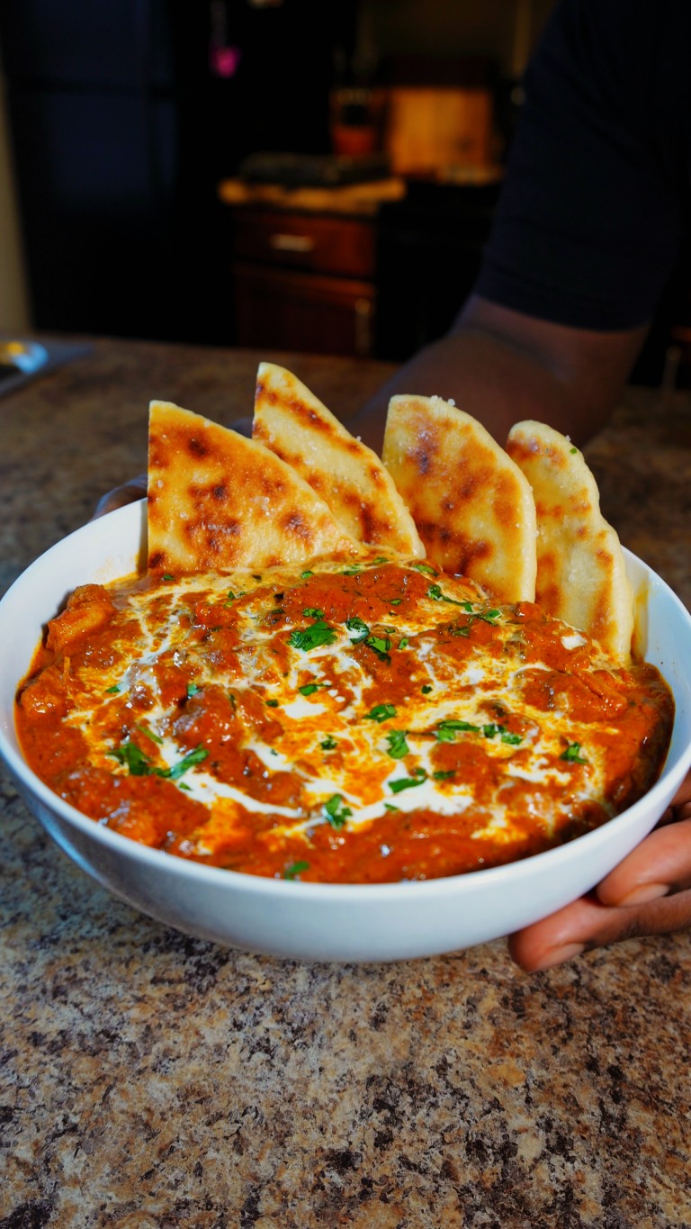 chicken tikka masala in bowl with naan