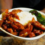 bourbon chicken in a bowl with broccoli and white rice