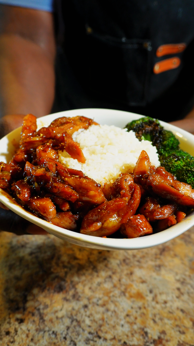 bourbon chicken in a bowl with broccoli and white rice