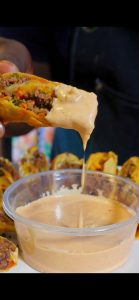 Cheeseburger Egg roll with burger sauce dripping from it
