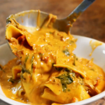 Lasagna soup being ladled into bowl