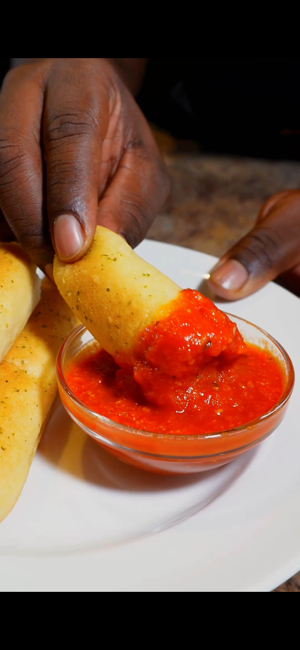 breadstick dipped in homemade marinara