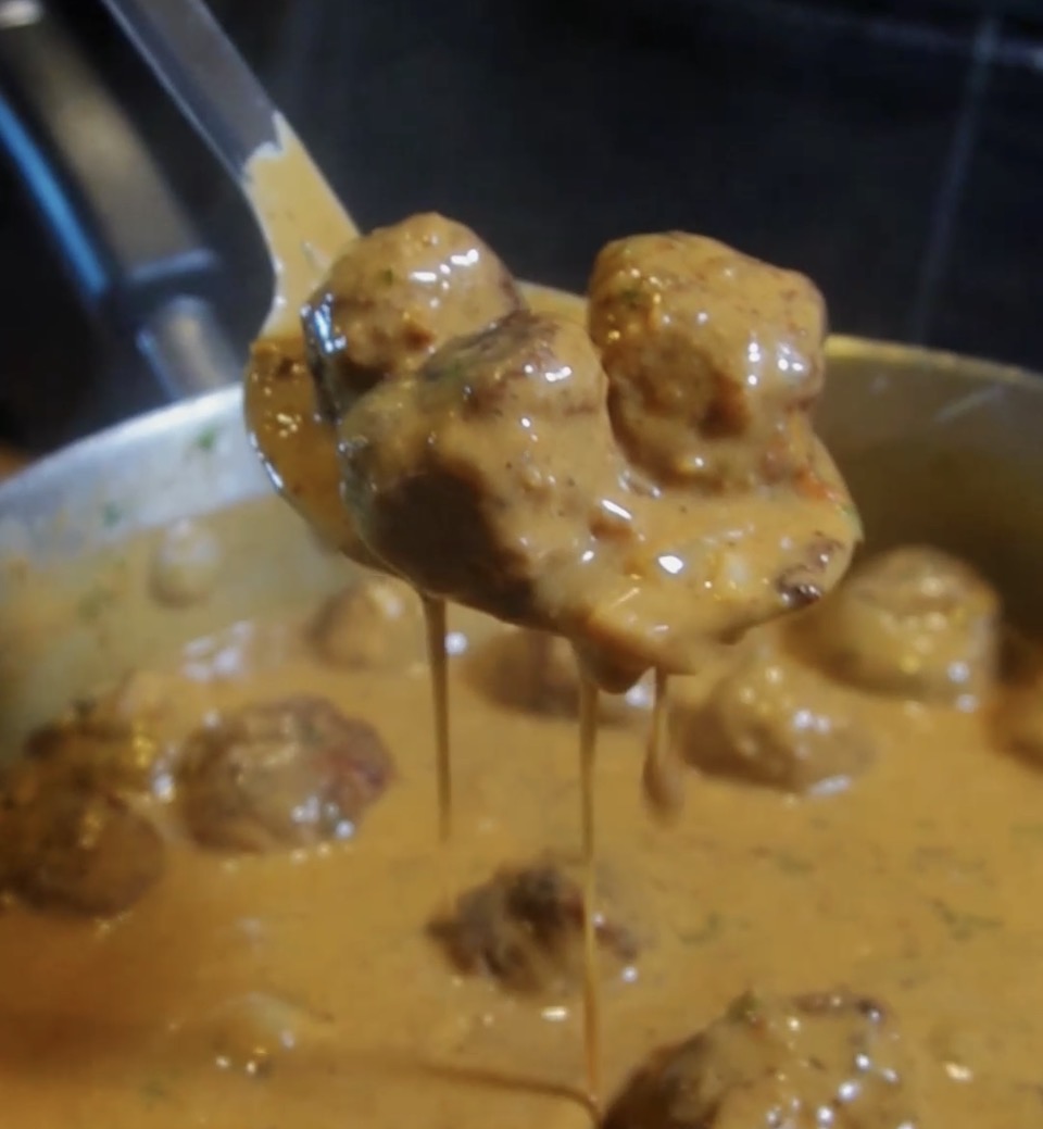 swedish meatballs on a spoon with gracy dripping