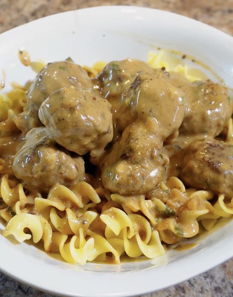 swedish meatballs over egg noodles in a bowl