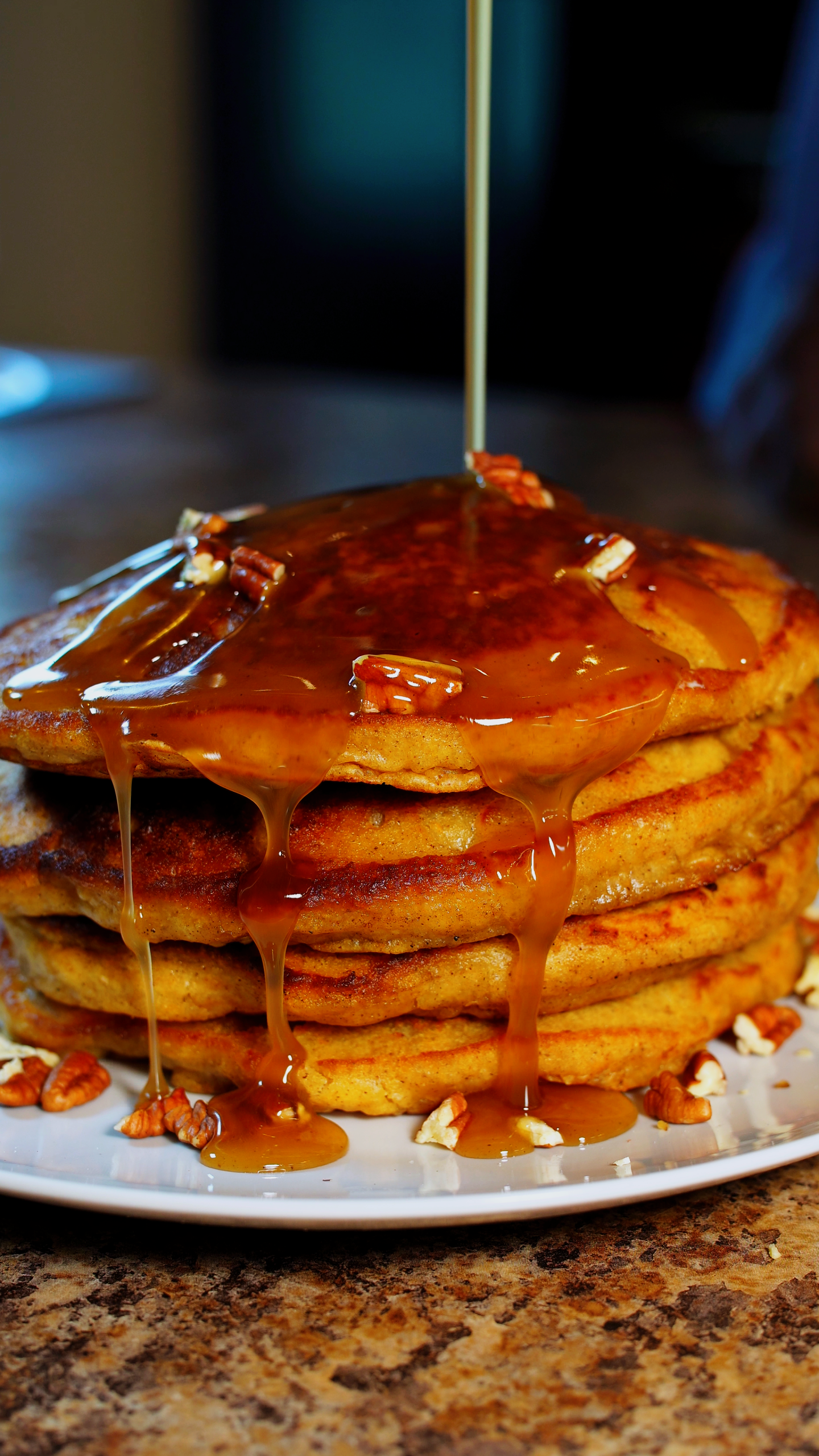 Stack of sweet potato pancakes with syrup drizzle
