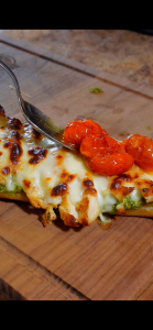 roasted cherry tomatoes on top of pesto sandwich