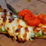 roasted cherry tomatoes on top of pesto sandwich