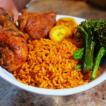Jollof rice in bowl with plantain chicken and broccoli