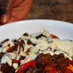 steak fajitas with mexican rice and queso drizzled over top