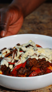 steak fajitas with mexican rice and queso drizzled over top