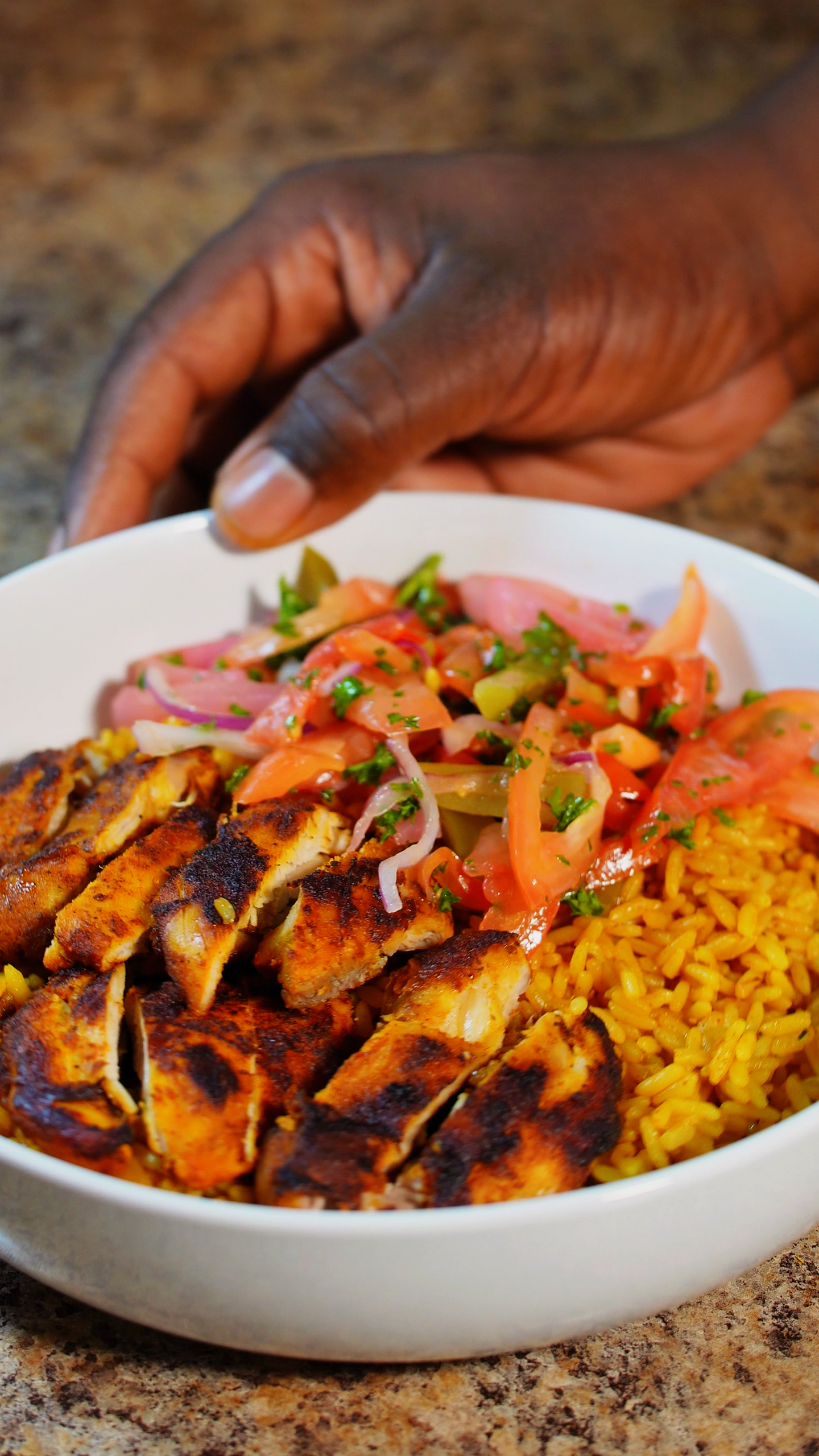 chicken shawarma in a bowl over rice with a salad