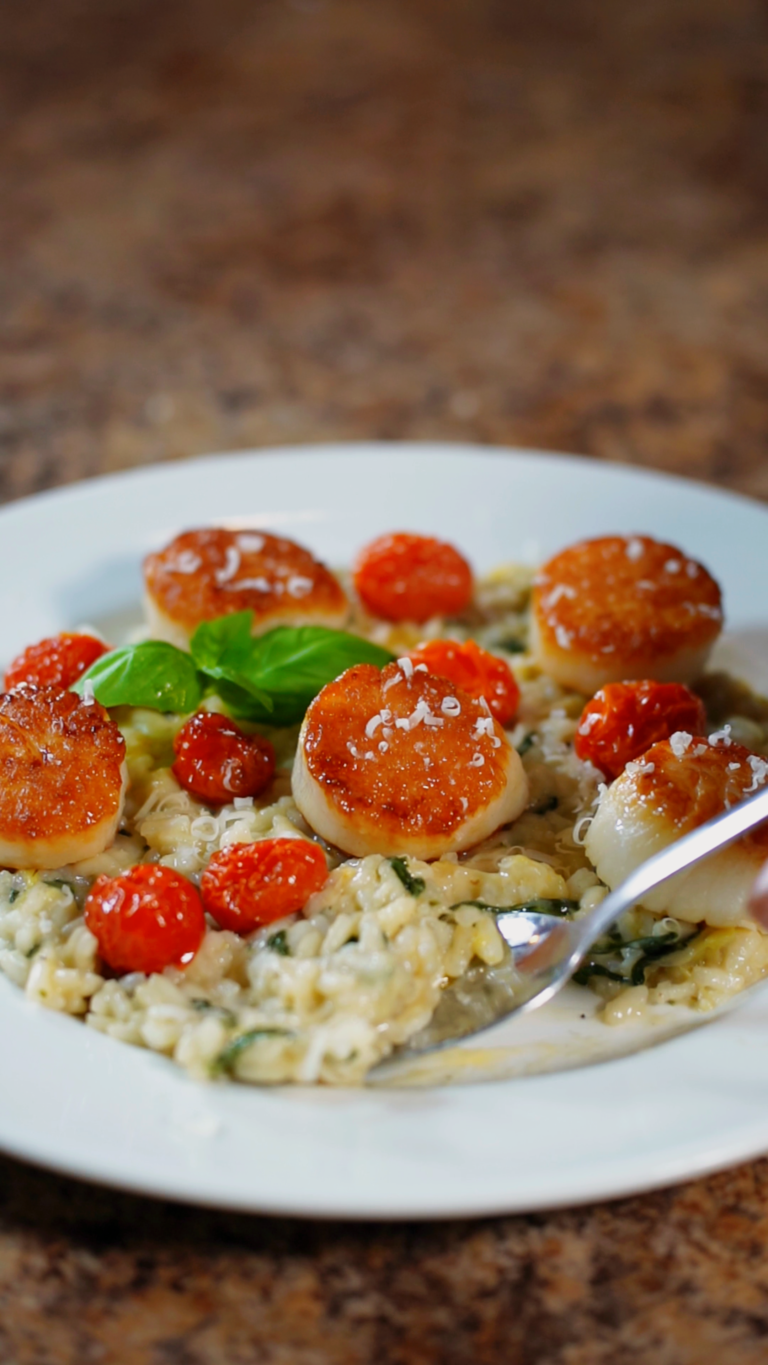 scooping spinach and artichoke risotto off of a plate